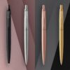 Four premium metal pens in black, silver, rose gold, and gold, designed for medical professionals and students.